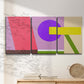 Three-panel canvas wall art featuring bold geometric color abstraction, displayed in a minimalist living room above a console table.