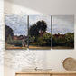 Three-panel canvas wall art featuring garden corner with flowering trees, displayed in a minimalist living room above a console table.