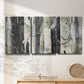 Three-panel canvas wall art featuring vertical abstract tree forms, displayed in a minimalist living room above a console table.