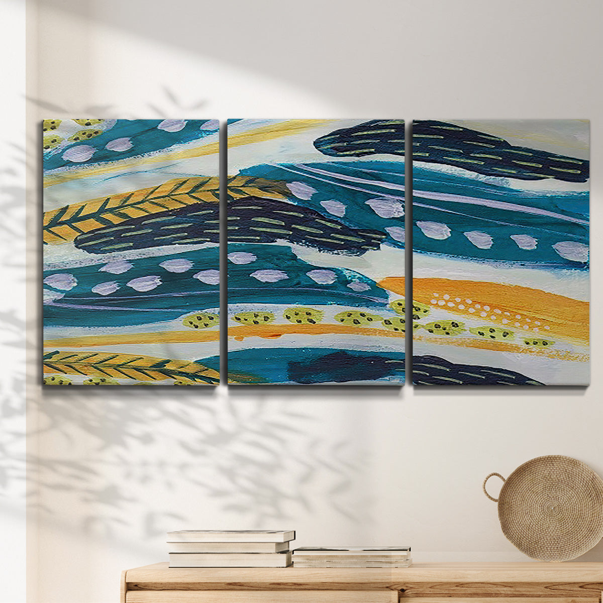 Three-panel canvas wall art featuring feather inspired abstract linear motion, displayed in a minimalist living room above a console table.