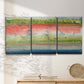 Three-panel canvas wall art featuring layered abstract color banding, displayed in a minimalist living room above a console table.