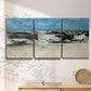 Three-panel canvas wall art featuring abstract bridge landscape in cyan, displayed in a minimalist living room above a console table.