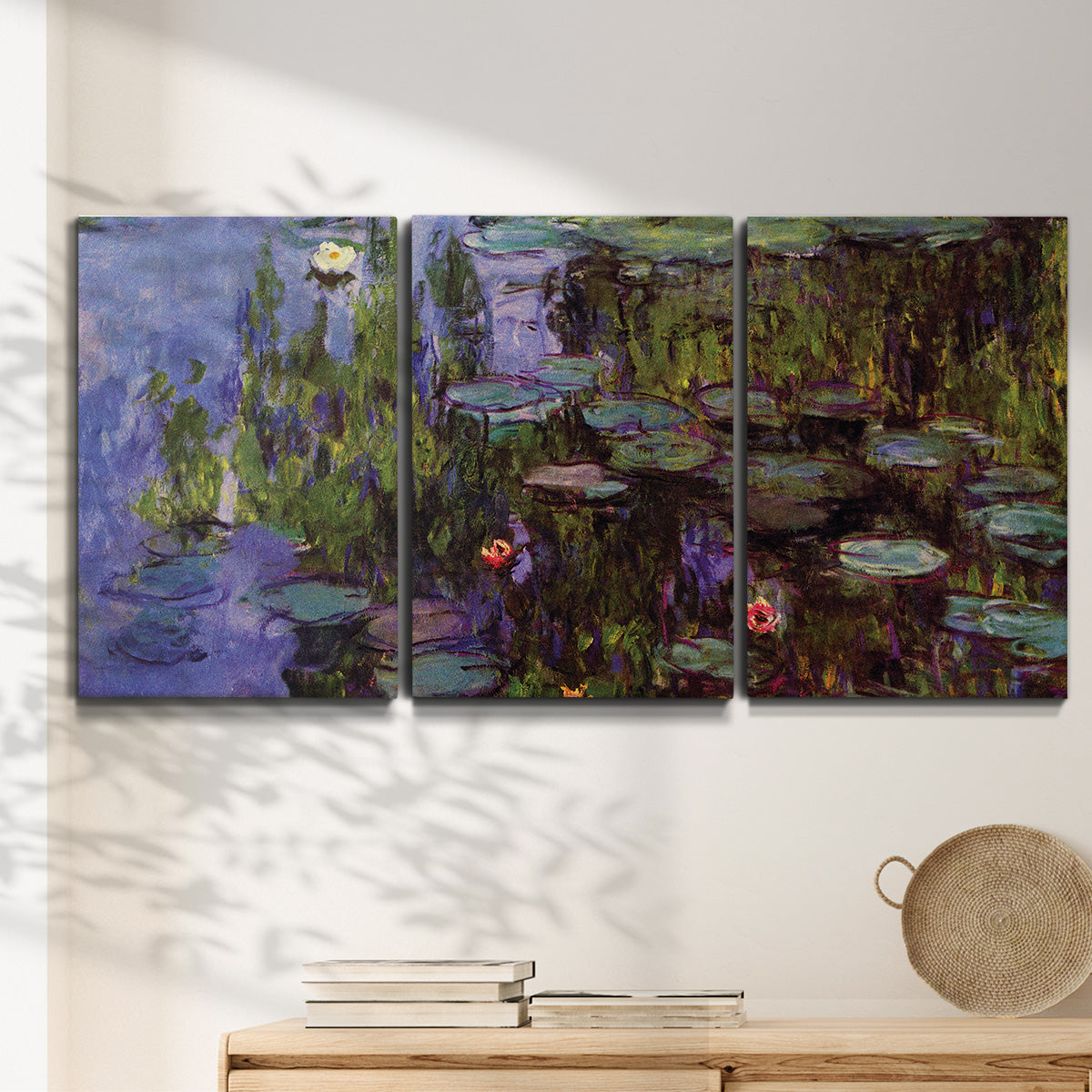 Three-panel canvas wall art featuring water lilies on calm pond, displayed in a minimalist living room above a console table.