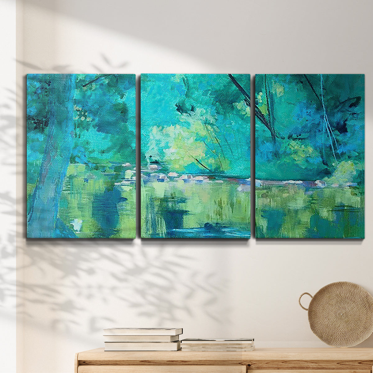 Three-panel canvas wall art featuring abstract river composition with movement, displayed in a minimalist living room above a console table.