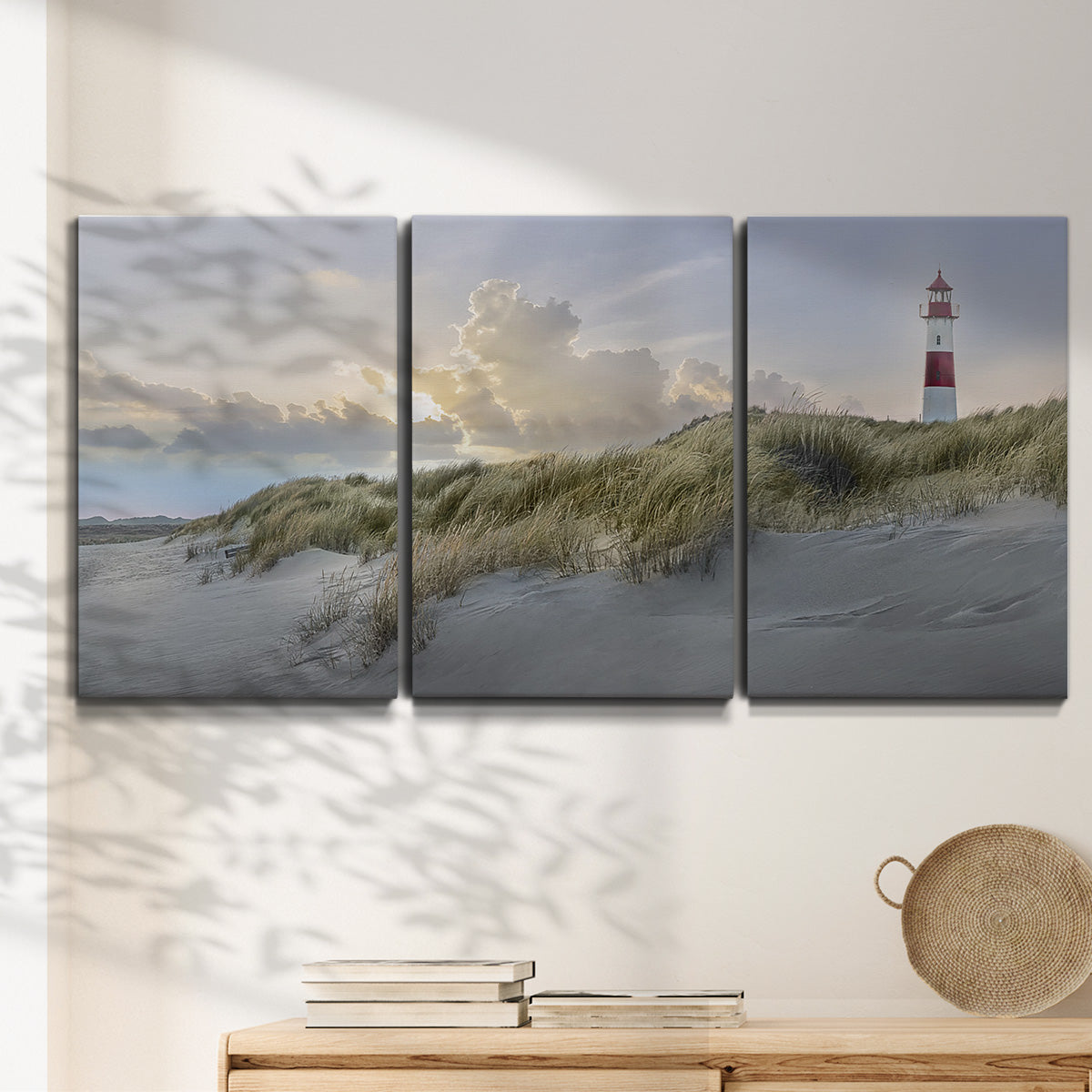 Three-panel canvas wall art featuring guardian boat along shoreline, displayed in a minimalist living room above a console table.
