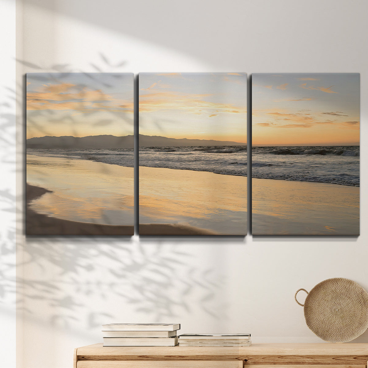 Three-panel canvas wall art featuring quiet tropical shoreline at low tide, displayed in a minimalist living room above a console table.