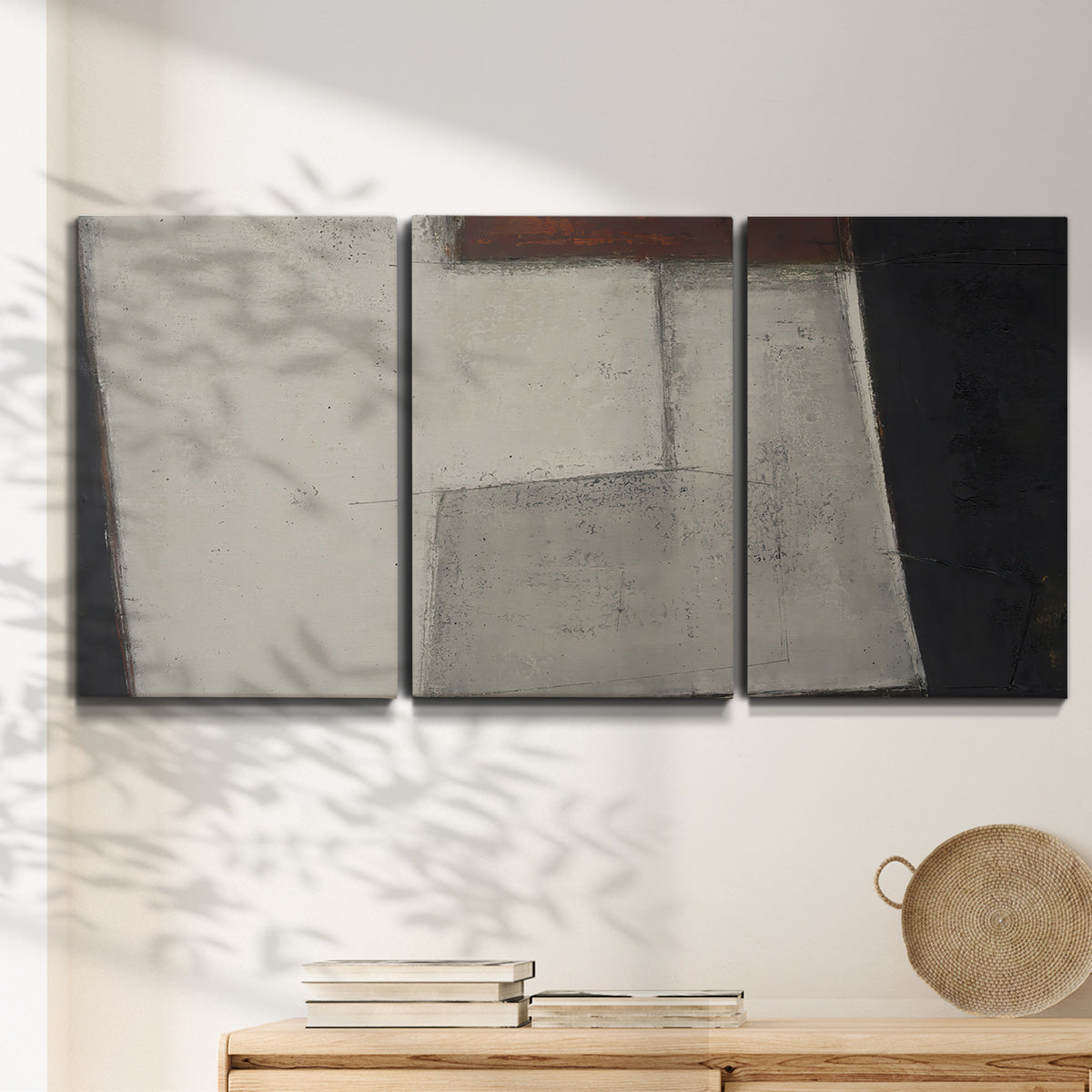 Three-panel canvas wall art featuring geometric abstract roadway motif, displayed in a minimalist living room above a console table.