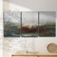 Three-panel canvas wall art featuring soft abstract evening light, displayed in a minimalist living room above a console table.