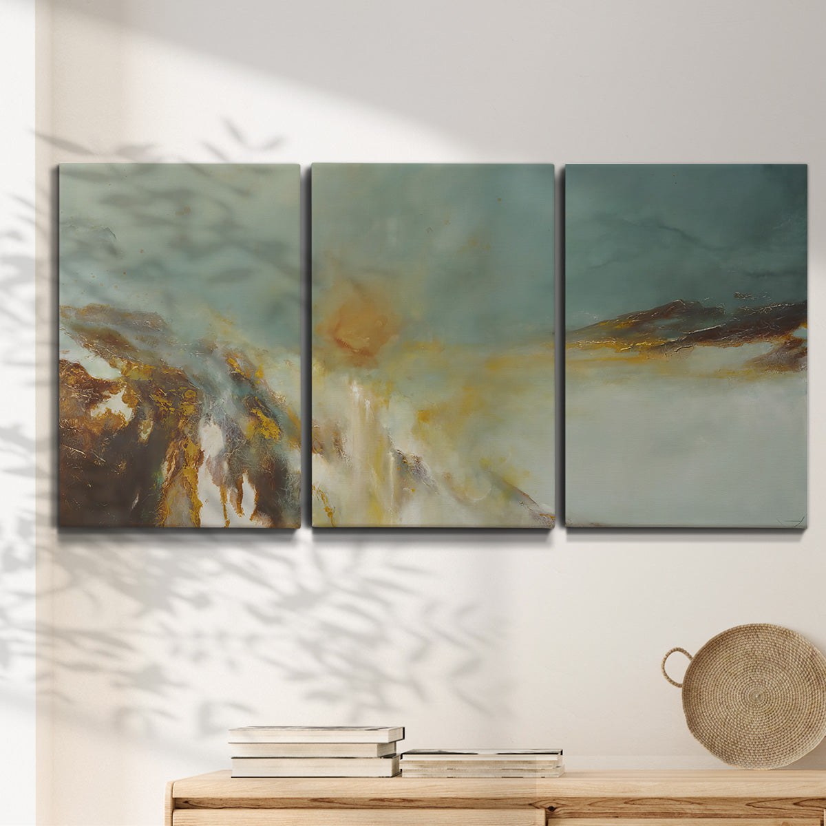 Three-panel canvas wall art featuring earth toned abstract solar landscape, displayed in a minimalist living room above a console table.