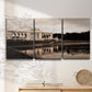 Three-panel canvas wall art featuring monochrome historic pavilion photograph, displayed in a minimalist living room above a console table.
