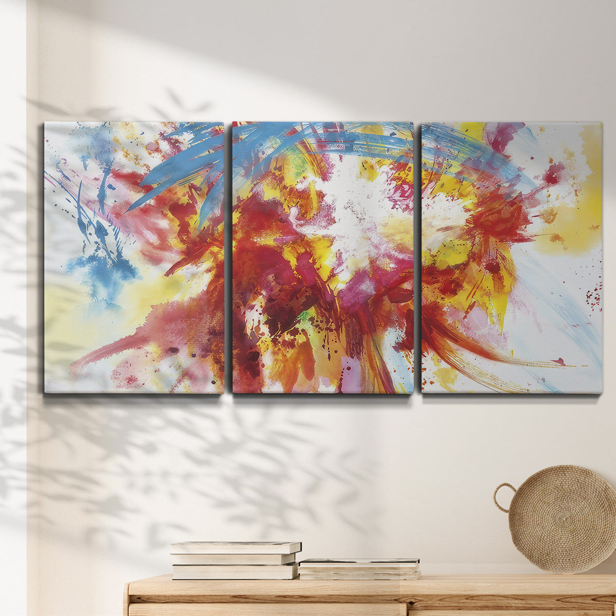 Three-panel canvas wall art featuring bright abstract summer palette, displayed in a minimalist living room above a console table.