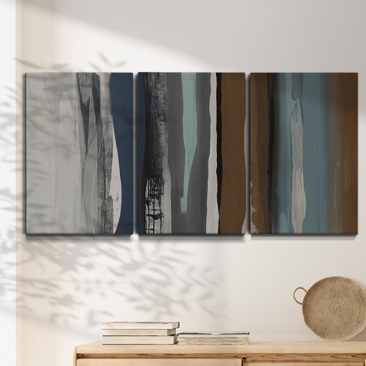 Three-panel canvas wall art featuring layered abstract amusement park tones, displayed in a minimalist living room above a console table.