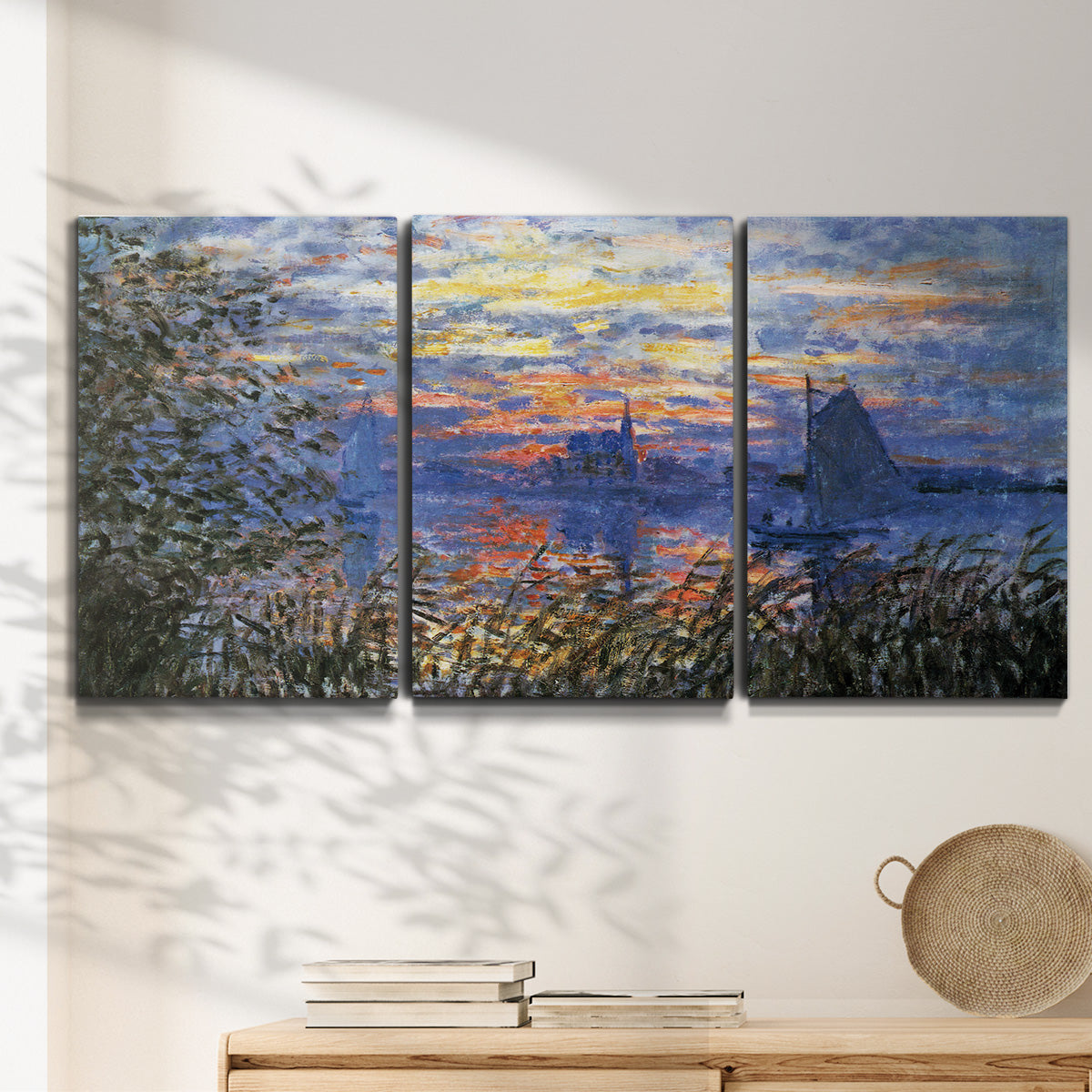 Three-panel canvas wall art featuring river sunset with reflections, displayed in a minimalist living room above a console table.