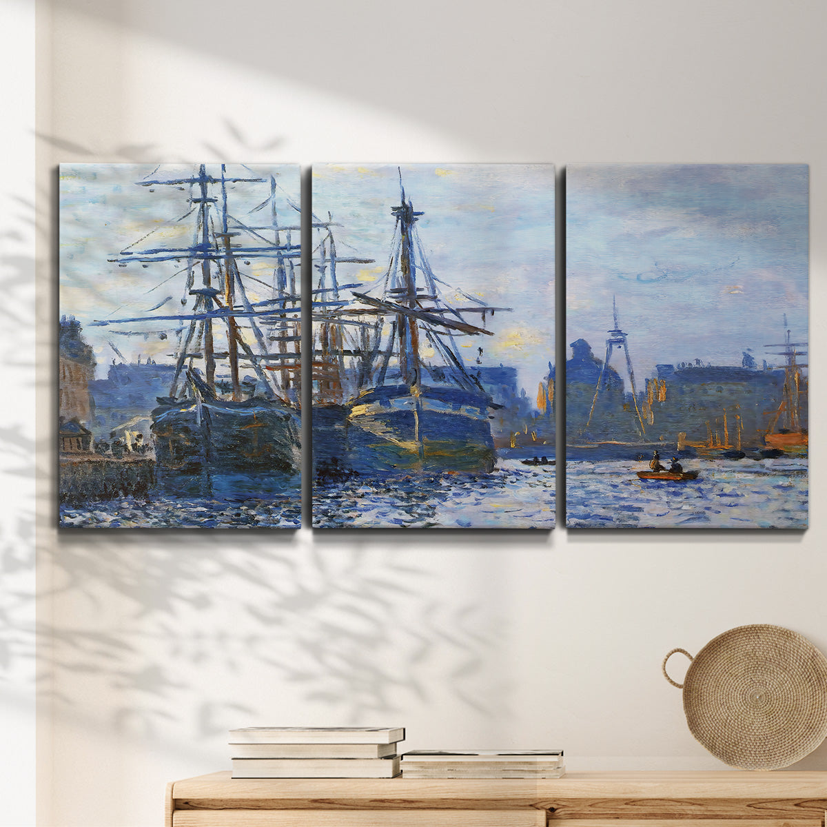 Three-panel canvas wall art featuring industrial dock along harbor, displayed in a minimalist living room above a console table.