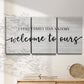 Three-panel canvas wall art featuring tropical beach at sunset photograph, displayed in a minimalist living room above a console table.