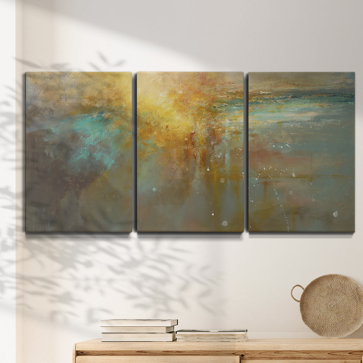 Three-panel canvas wall art featuring muted abstract river inspired tones, displayed in a minimalist living room above a console table.