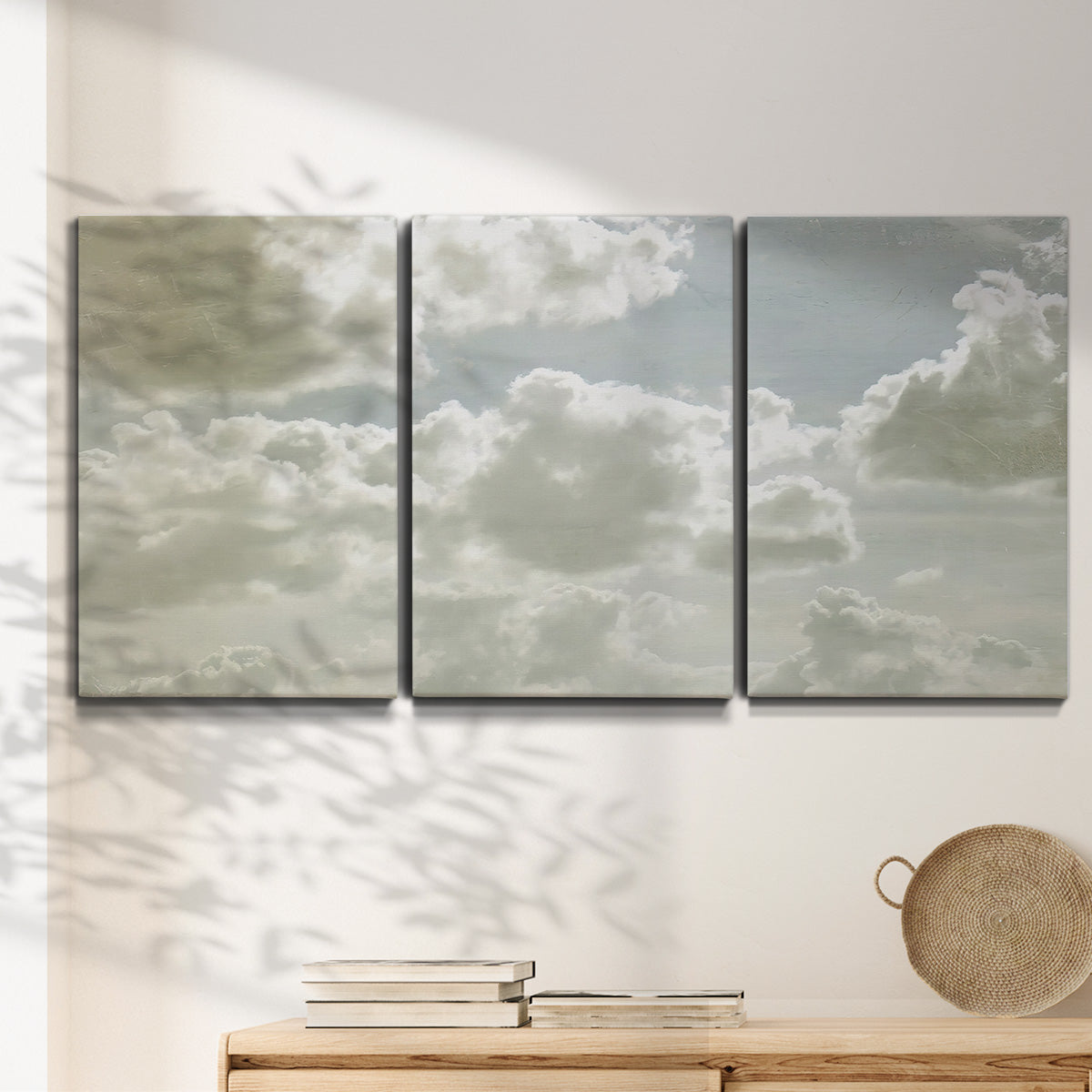 Three-panel canvas wall art featuring whimsical vertical tree landscape, displayed in a minimalist living room above a console table.