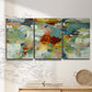Three-panel canvas wall art featuring celebratory abstract color movement, displayed in a minimalist living room above a console table.