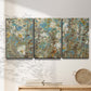 Three-panel canvas wall art featuring abstract flowering vine pattern, displayed in a minimalist living room above a console table.