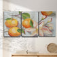 Three-panel canvas wall art featuring bright tangerine still life blossoms, displayed in a minimalist living room above a console table.