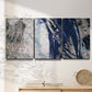 Three-panel canvas wall art featuring layered blue abstract texture, displayed in a minimalist living room above a console table.