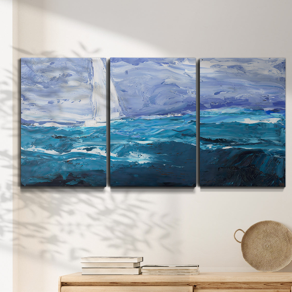 Three-panel canvas wall art featuring impressionist nautical harbor scene, displayed in a minimalist living room above a console table.