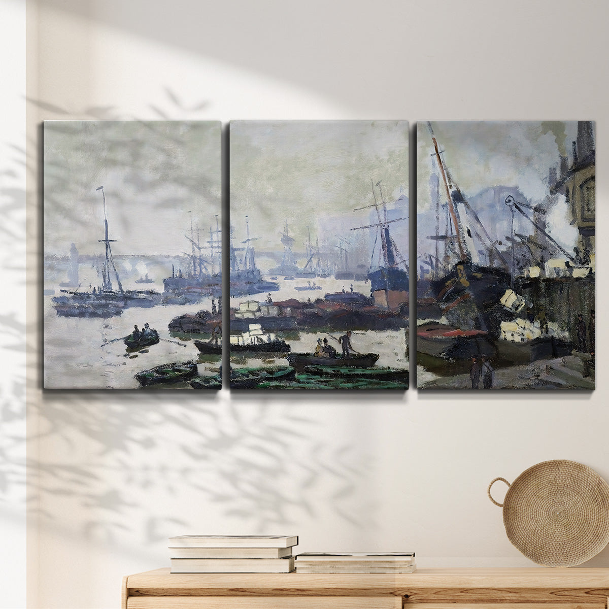 Three-panel canvas wall art featuring working harbor with docked boats, displayed in a minimalist living room above a console table.