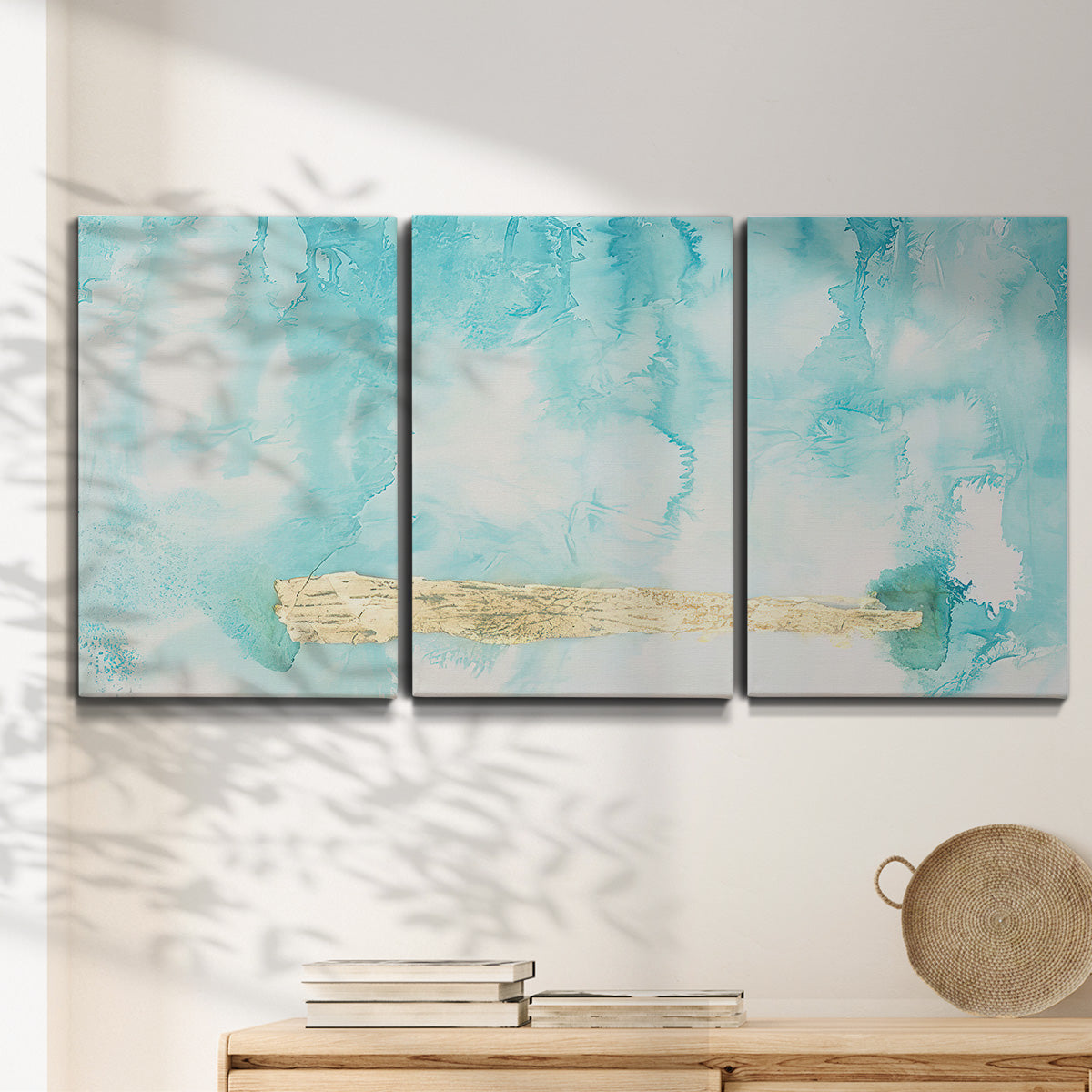 Three-panel canvas wall art featuring saturated abstract color fields, displayed in a minimalist living room above a console table.