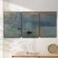 Three-panel canvas wall art featuring misty harbor sunrise with boats, displayed in a minimalist living room above a console table.