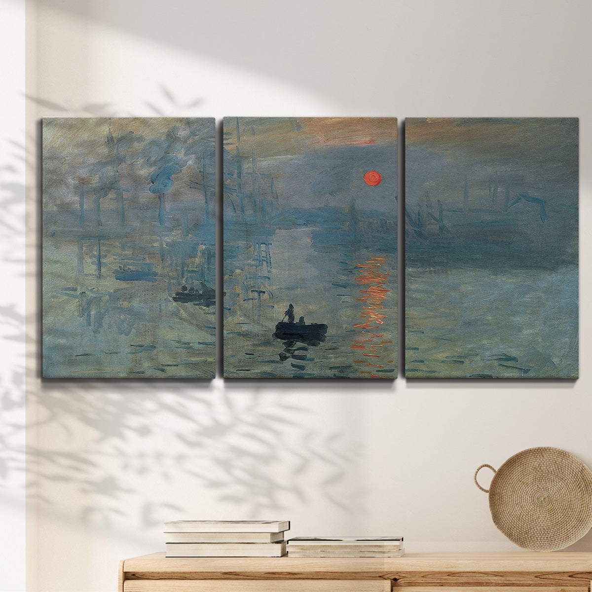 Three-panel canvas wall art featuring misty harbor sunrise with boats, displayed in a minimalist living room above a console table.