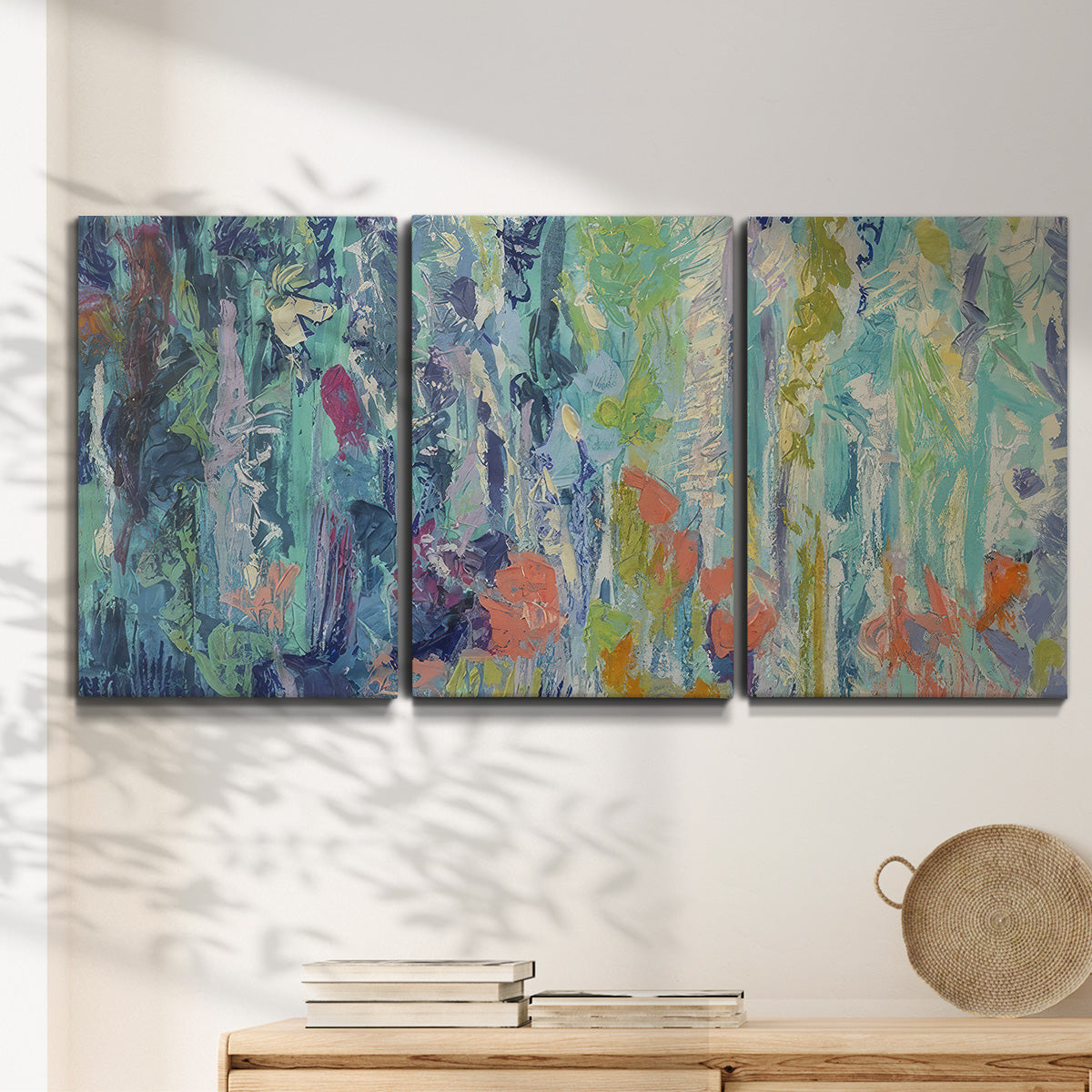 Three-panel canvas wall art featuring abstract rainfall with butterfly forms, displayed in a minimalist living room above a console table.