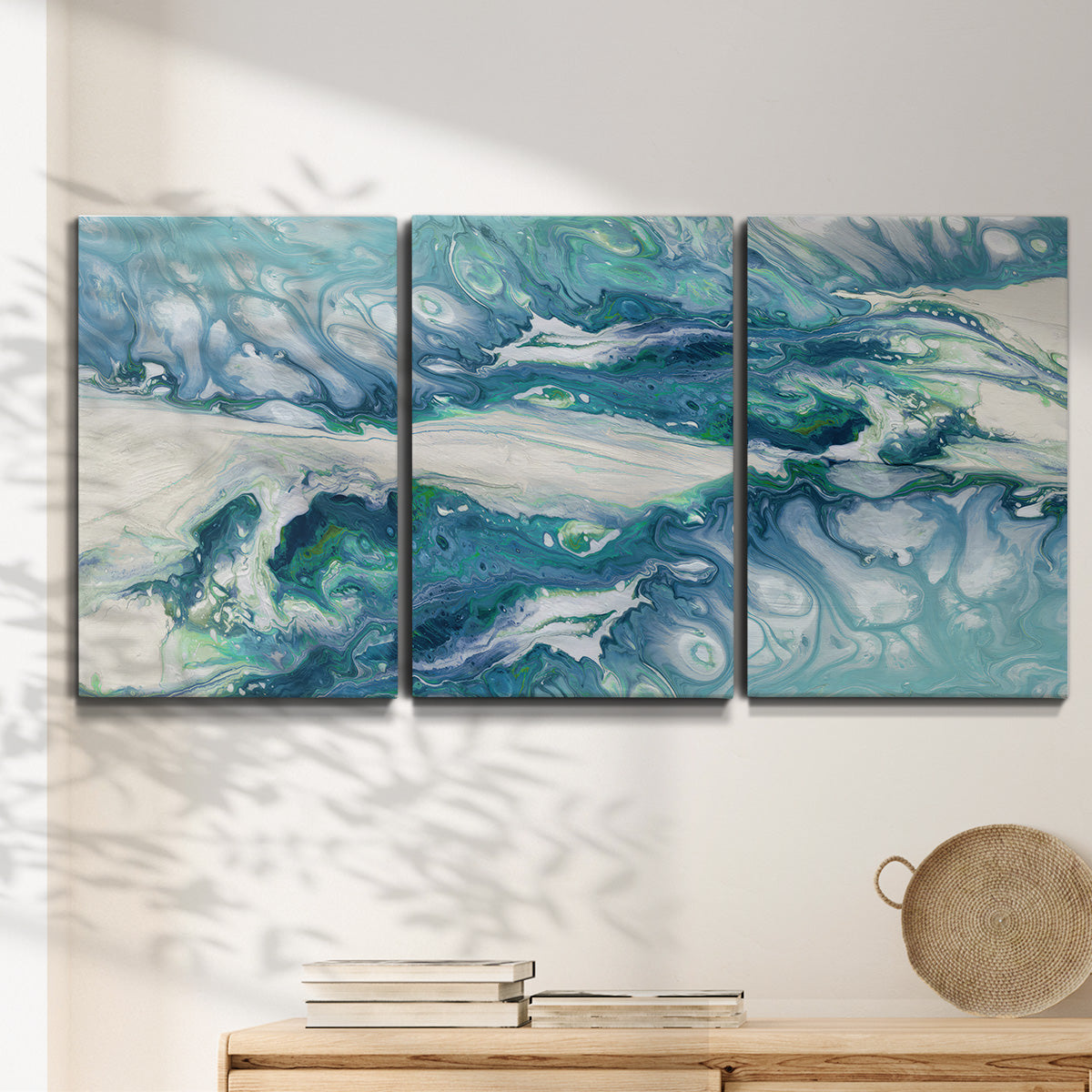 Three-panel canvas wall art featuring layered abstract marble textures, displayed in a minimalist living room above a console table.