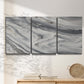 Three-panel canvas wall art featuring minimal monochrome abstract forms, displayed in a minimalist living room above a console table.