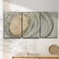 Three-panel canvas wall art featuring circular abstract energy forms, displayed in a minimalist living room above a console table.