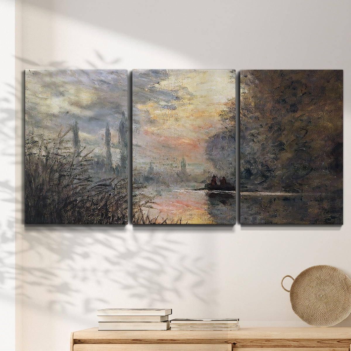 Three-panel canvas wall art featuring winter river sunset with reflections, displayed in a minimalist living room above a console table.