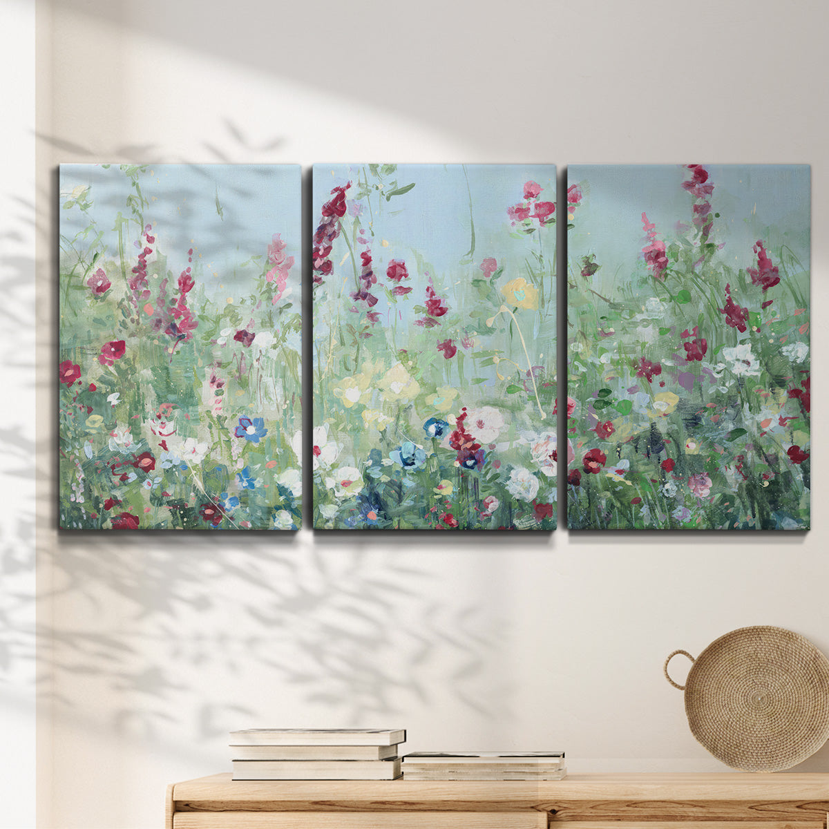 Three-panel canvas wall art featuring night landscape silhouette photography, displayed in a minimalist living room above a console table.