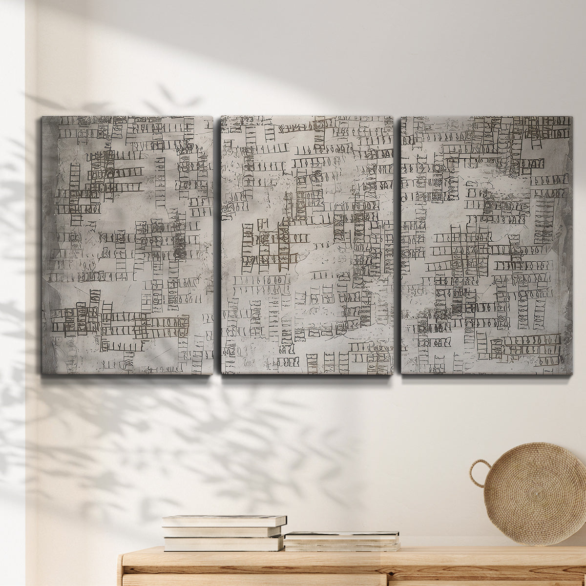 Three-panel canvas wall art featuring grid based geometric abstraction, displayed in a minimalist living room above a console table.