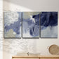 Three-panel canvas wall art featuring abstract sky break composition, displayed in a minimalist living room above a console table.
