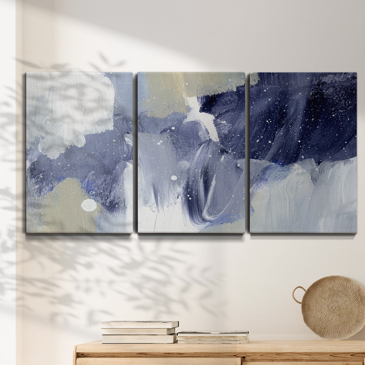 Three-panel canvas wall art featuring abstract sky break composition, displayed in a minimalist living room above a console table.