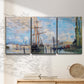 Three-panel canvas wall art featuring busy river port scene, displayed in a minimalist living room above a console table.