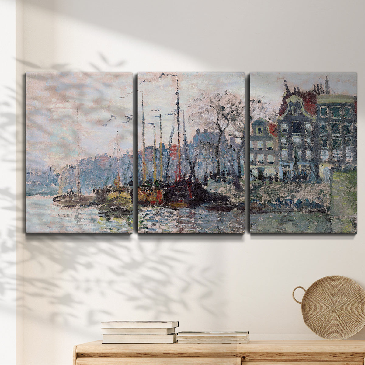 Three-panel canvas wall art featuring historic canal view with boats, displayed in a minimalist living room above a console table.