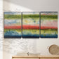 Three-panel canvas wall art featuring layered abstract color banding, displayed in a minimalist living room above a console table.