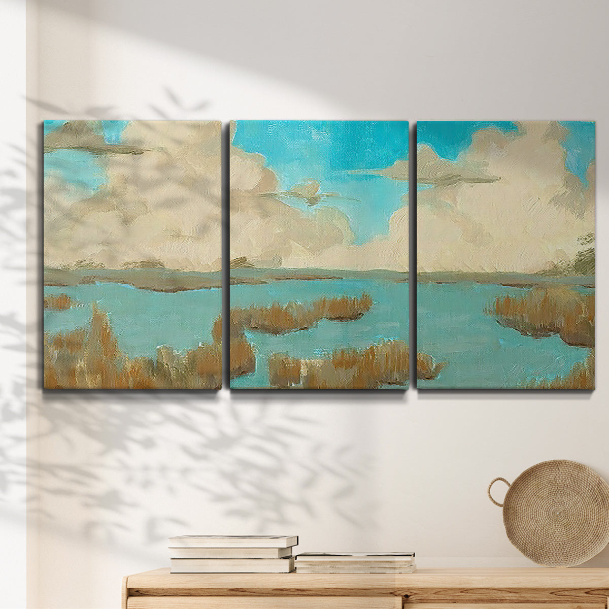 Three-panel canvas wall art featuring abstract pond scene with reflections, displayed in a minimalist living room above a console table.