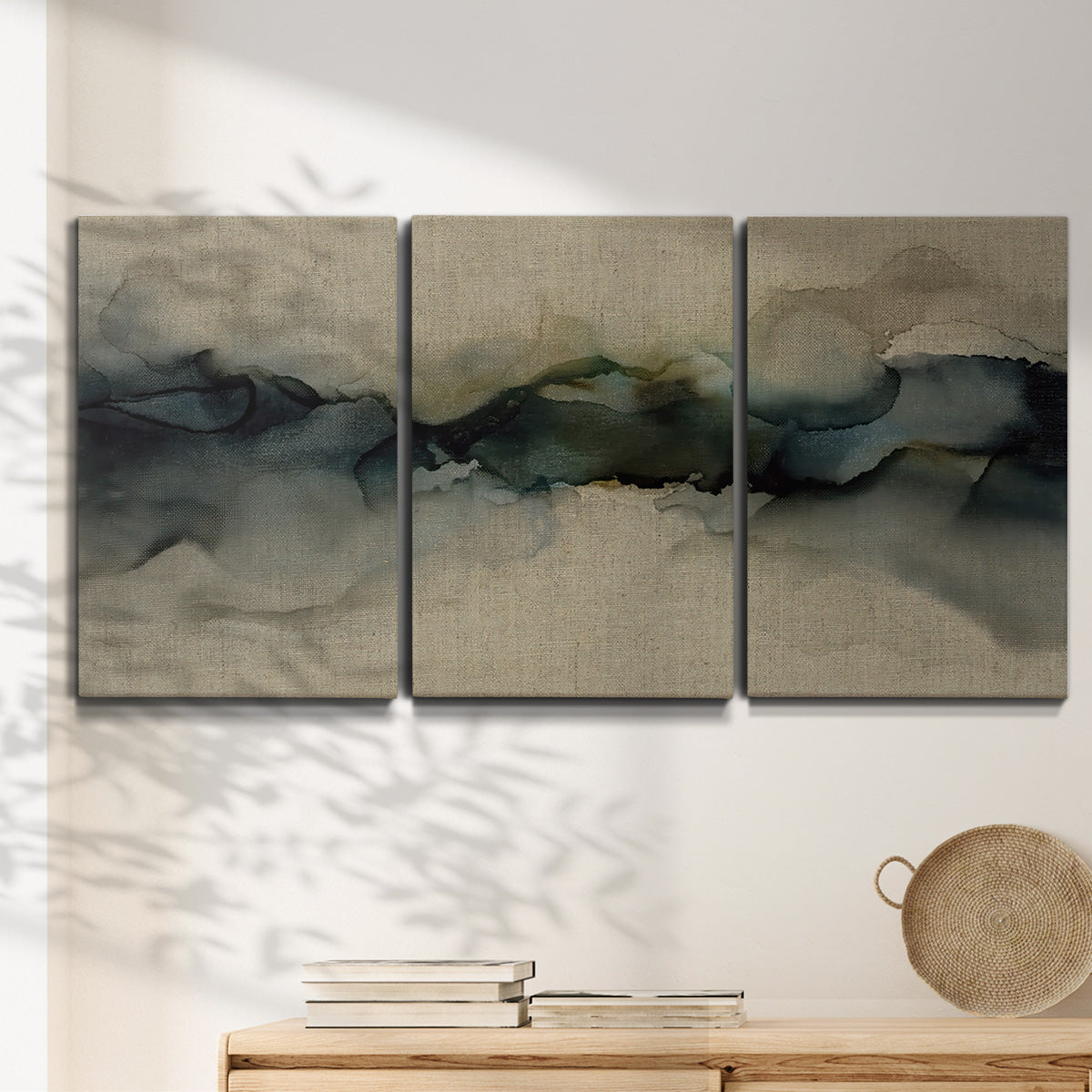 Three-panel canvas wall art featuring calm abstract water surface stillness, displayed in a minimalist living room above a console table.