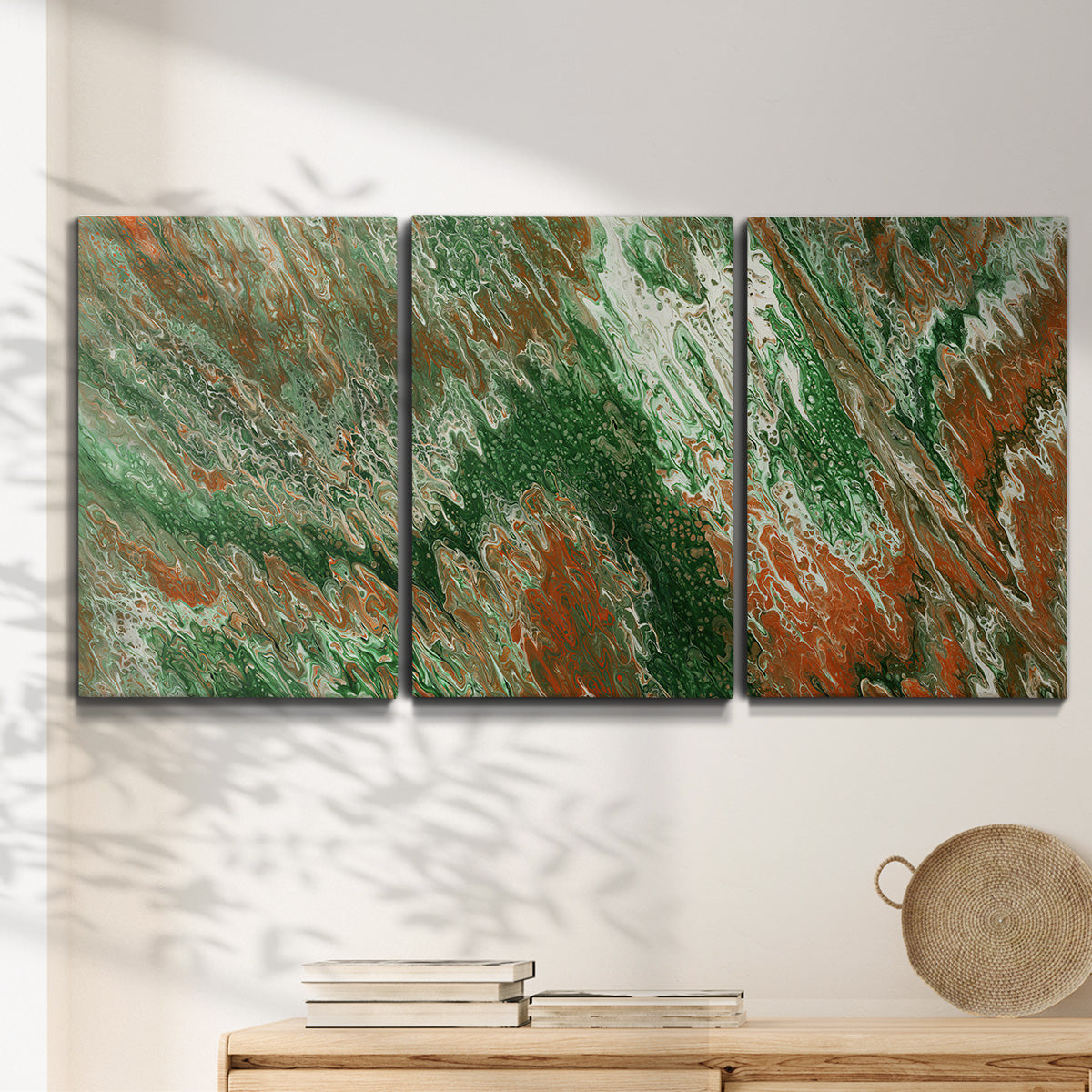 Three-panel canvas wall art featuring modern abstract layered pattern, displayed in a minimalist living room above a console table.