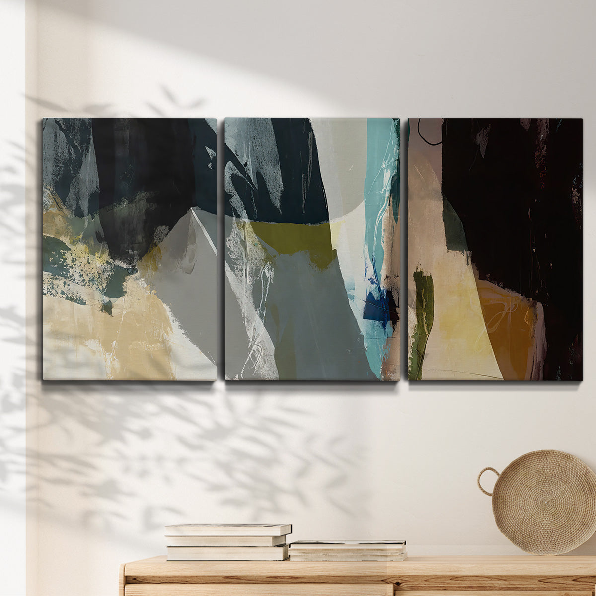 Three-panel canvas wall art featuring layered neutral abstract textures, displayed in a minimalist living room above a console table.