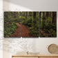 Three-panel canvas wall art featuring forest trail landscape photograph, displayed in a minimalist living room above a console table.