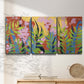 Three-panel canvas wall art featuring bold colorful floral abstraction, displayed in a minimalist living room above a console table.