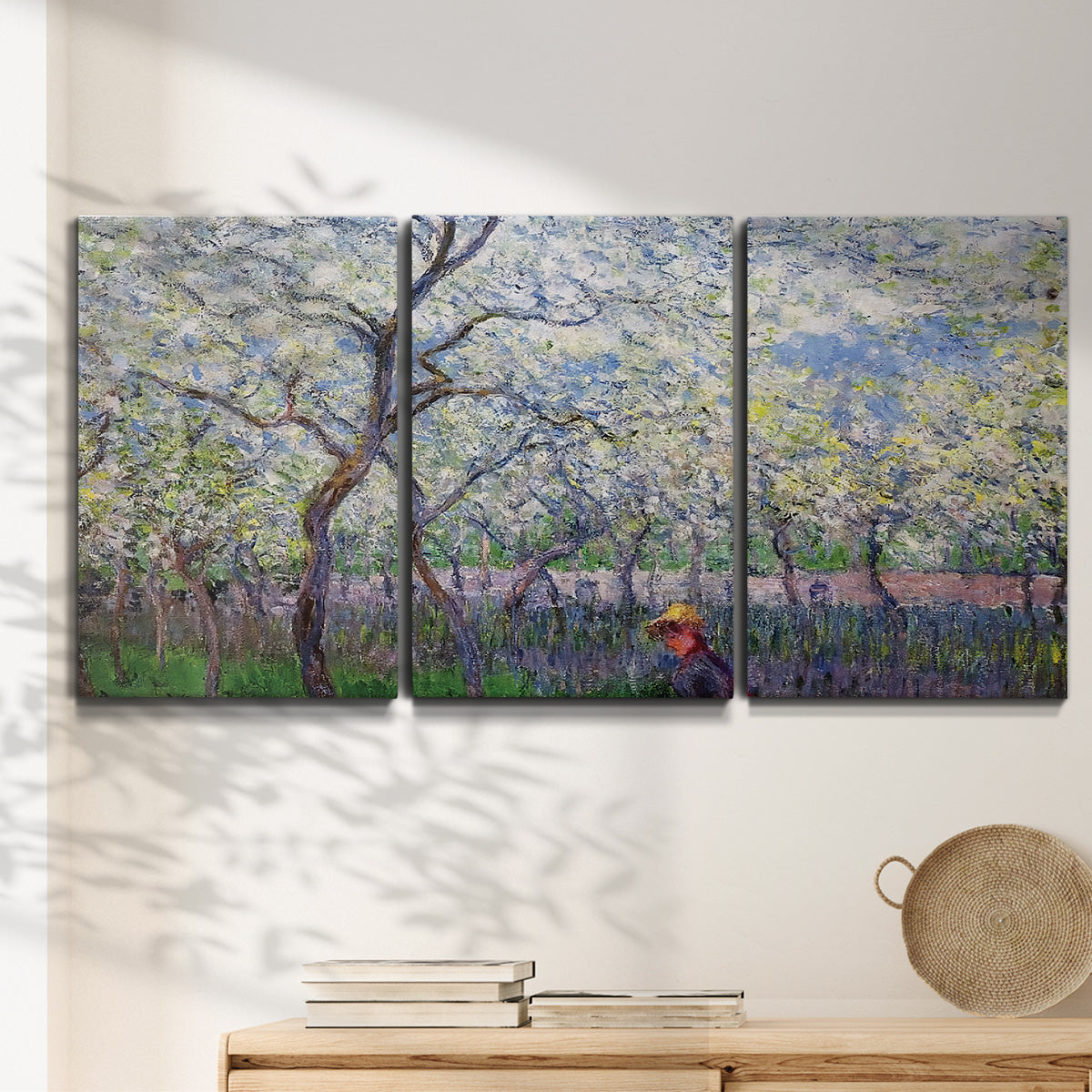Three-panel canvas wall art featuring fresh spring countryside landscape, displayed in a minimalist living room above a console table.