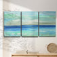Three-panel canvas wall art featuring vast open blue ocean horizon, displayed in a minimalist living room above a console table.
